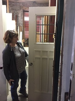Sally looking at a salvaged door.